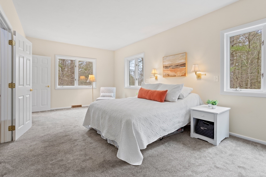 88 Coventry Wood Road Bolton, MA 01740 - Photo 25 of 41 a bed sitting in a bedroom next to a window