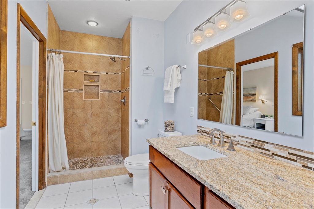 88 Coventry Wood Road Bolton, MA 01740 - Photo 26 of 41 a bathroom with a granite countertop sink mirror and shower