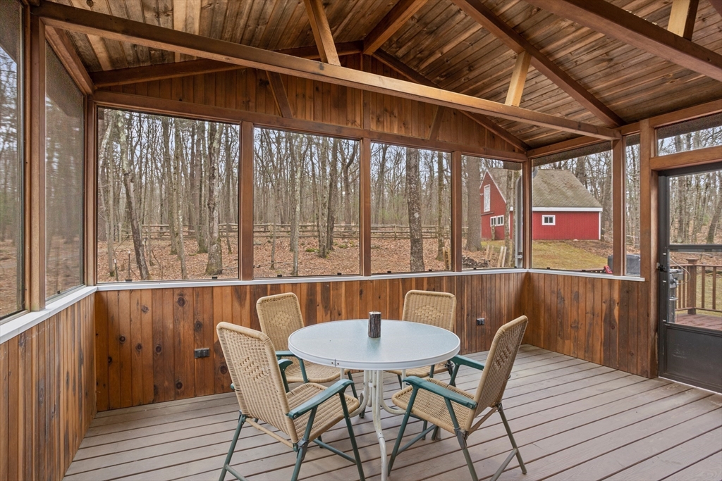 88 Coventry Wood Road Bolton, MA 01740 - Photo 28 of 41 a balcony with table and chairs