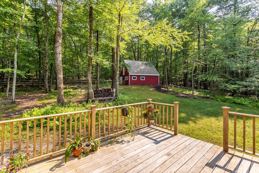 88 Coventry Wood Road Bolton, MA 01740 - Photo 29 of 41 a view of balcony with wooden floor and lake view