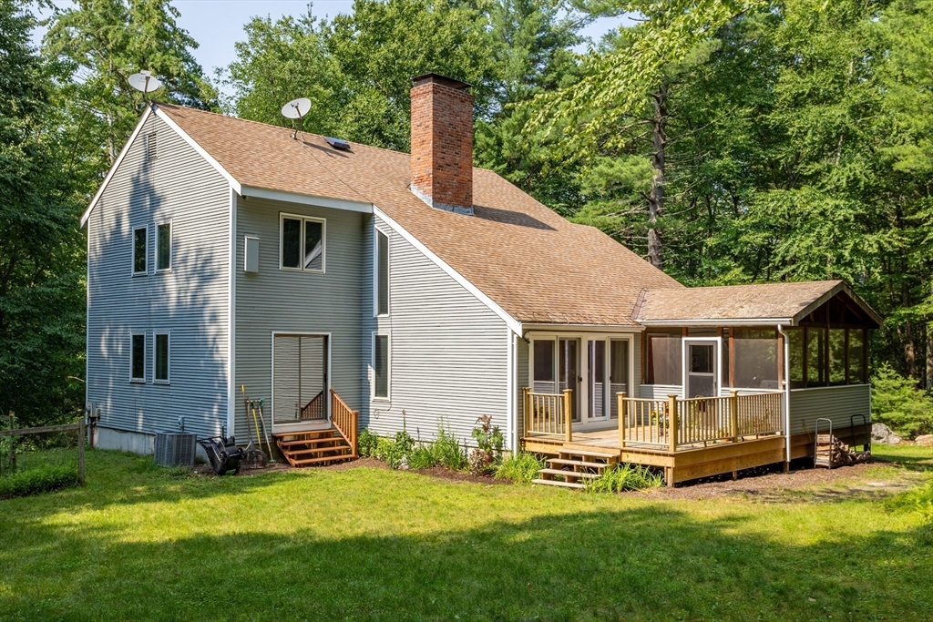 88 Coventry Wood Road Bolton, MA 01740 - Photo 30 of 41 a view of a house with a yard and sitting area
