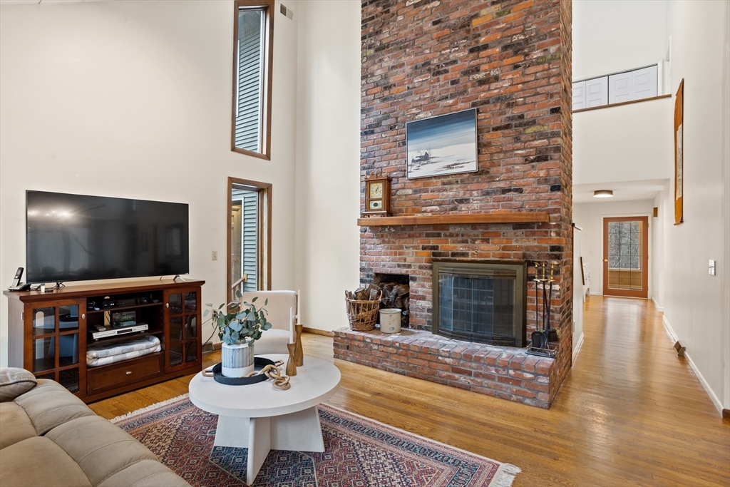 88 Coventry Wood Road Bolton, MA 01740 - Photo 3 of 41 a living room with furniture and a fireplace