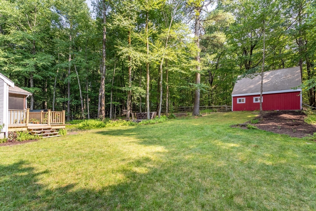 88 Coventry Wood Road Bolton, MA 01740 - Photo 34 of 41 a backyard of a house with table and chairs