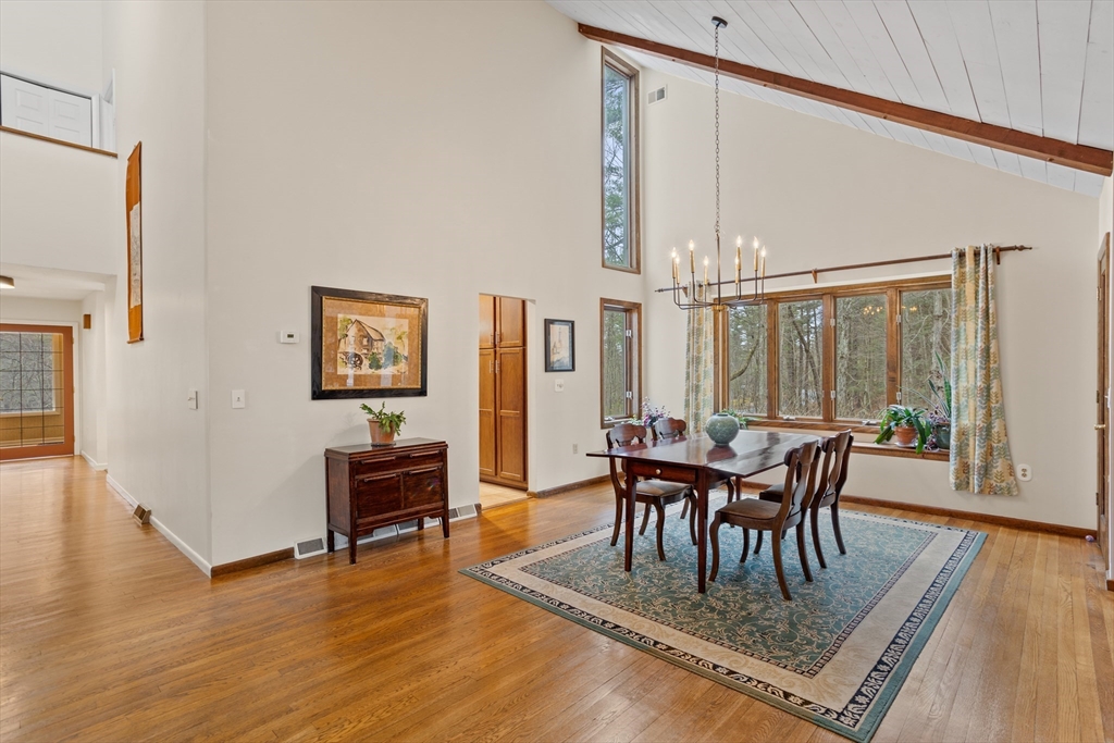 88 Coventry Wood Road Bolton, MA 01740 - Photo 7 of 41 a view of a dining room with furniture and wooden floor