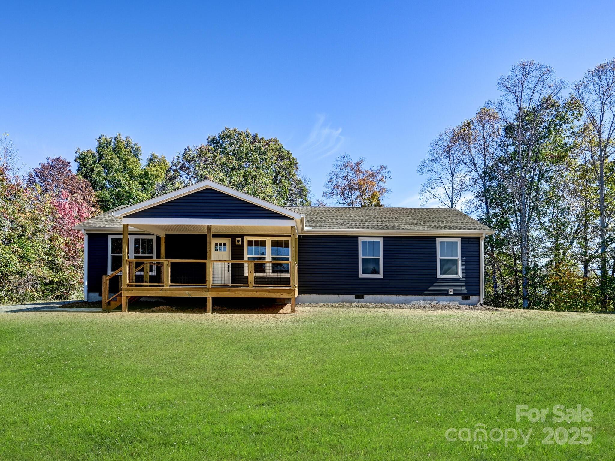 a view of a house with a yard and sitting area