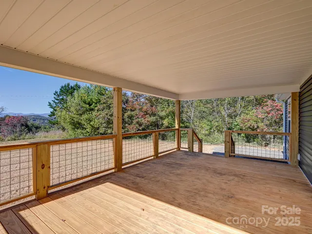 a view of a room with wooden floor and iron stairs
