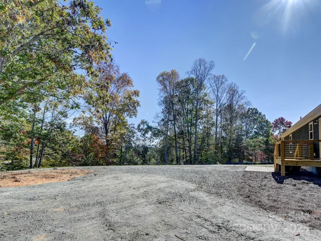a view of a yard with large trees