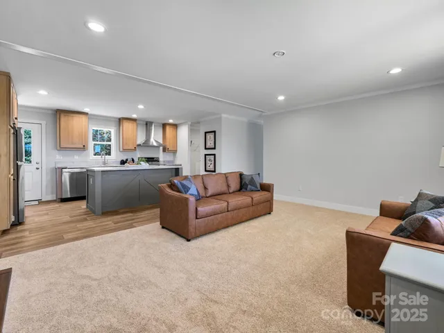 a living room with furniture and a kitchen