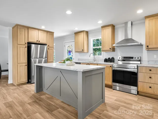 a kitchen with stainless steel appliances a refrigerator stove and sink
