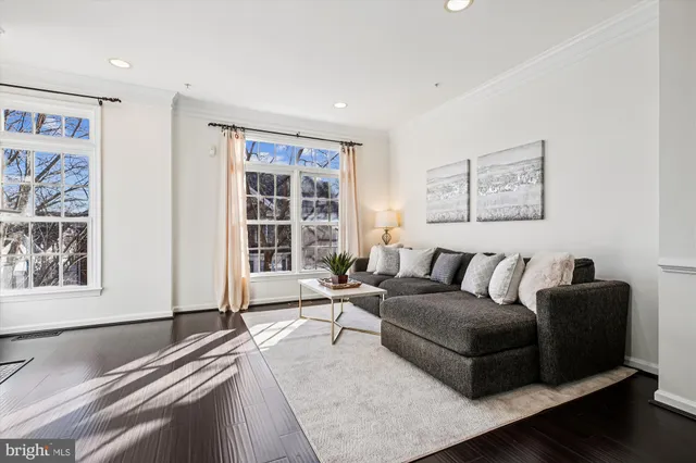 a kitchen with stainless steel appliances granite countertop a stove a sink a refrigerator and a granite counter tops with wooden floors