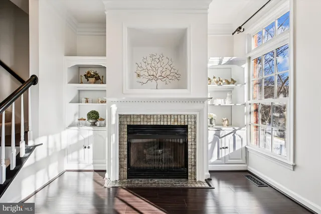 a kitchen with stainless steel appliances granite countertop a refrigerator a stove a sink a washer and cabinets with wooden floor