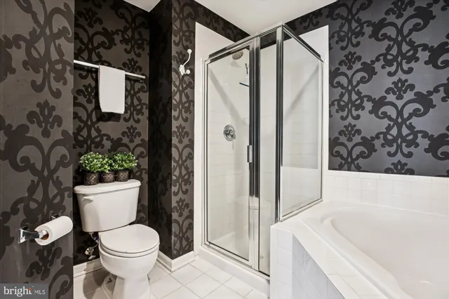 a living room with furniture and a flat screen tv with wooden floor