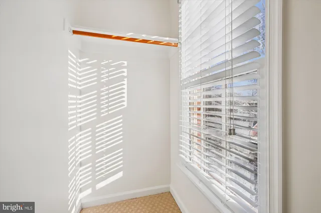 a room with gym equipment and large windows