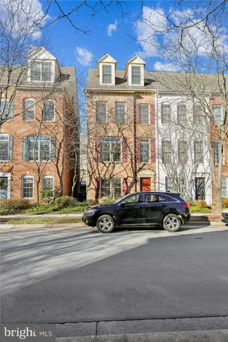 a living room with a fireplace and a floor to ceiling window