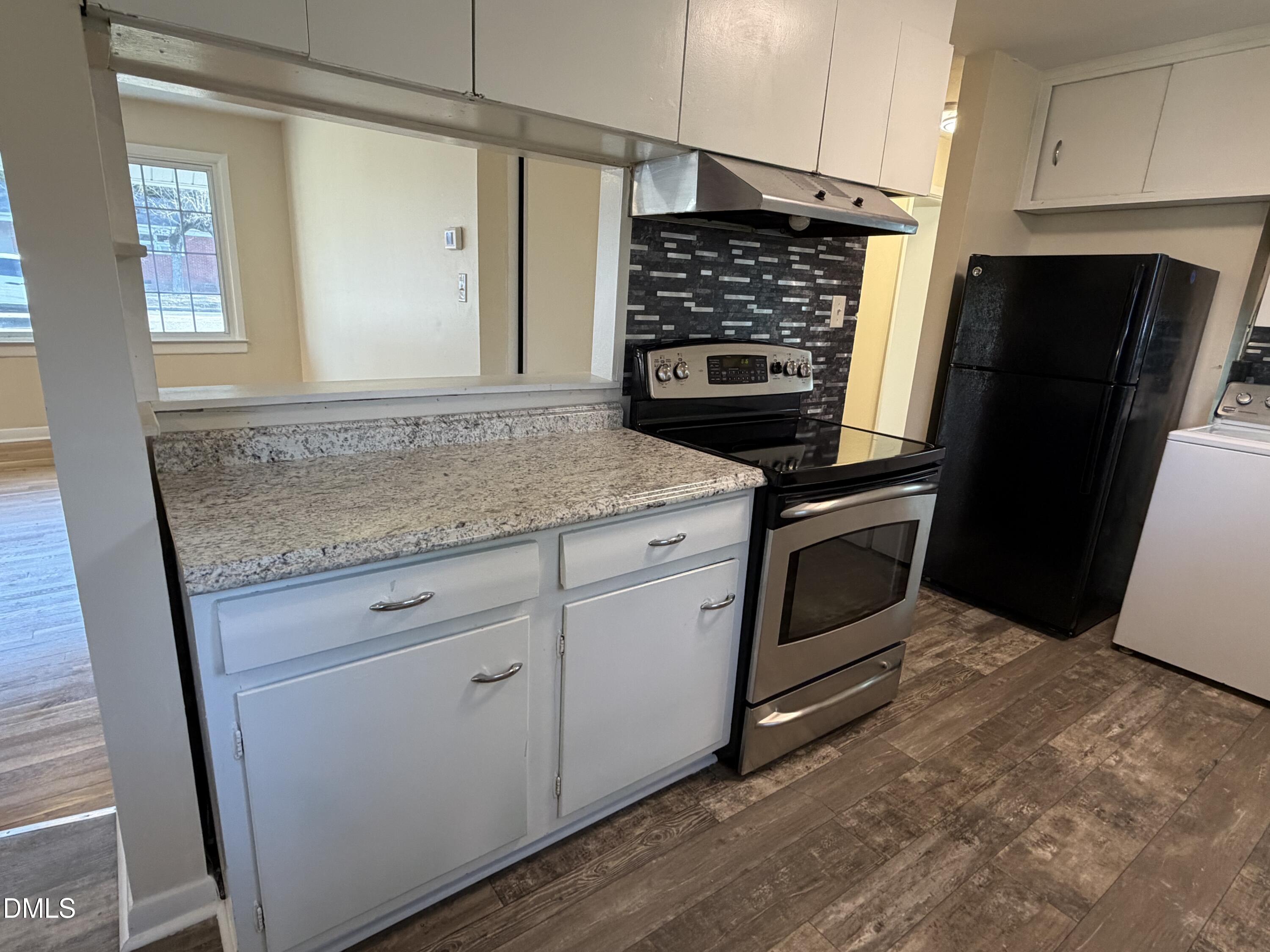 503 Spring Avenue Spring Lake, NC 28390 - Photo 12 of 36 a kitchen with granite countertop cabinets stainless steel appliances and a counter space