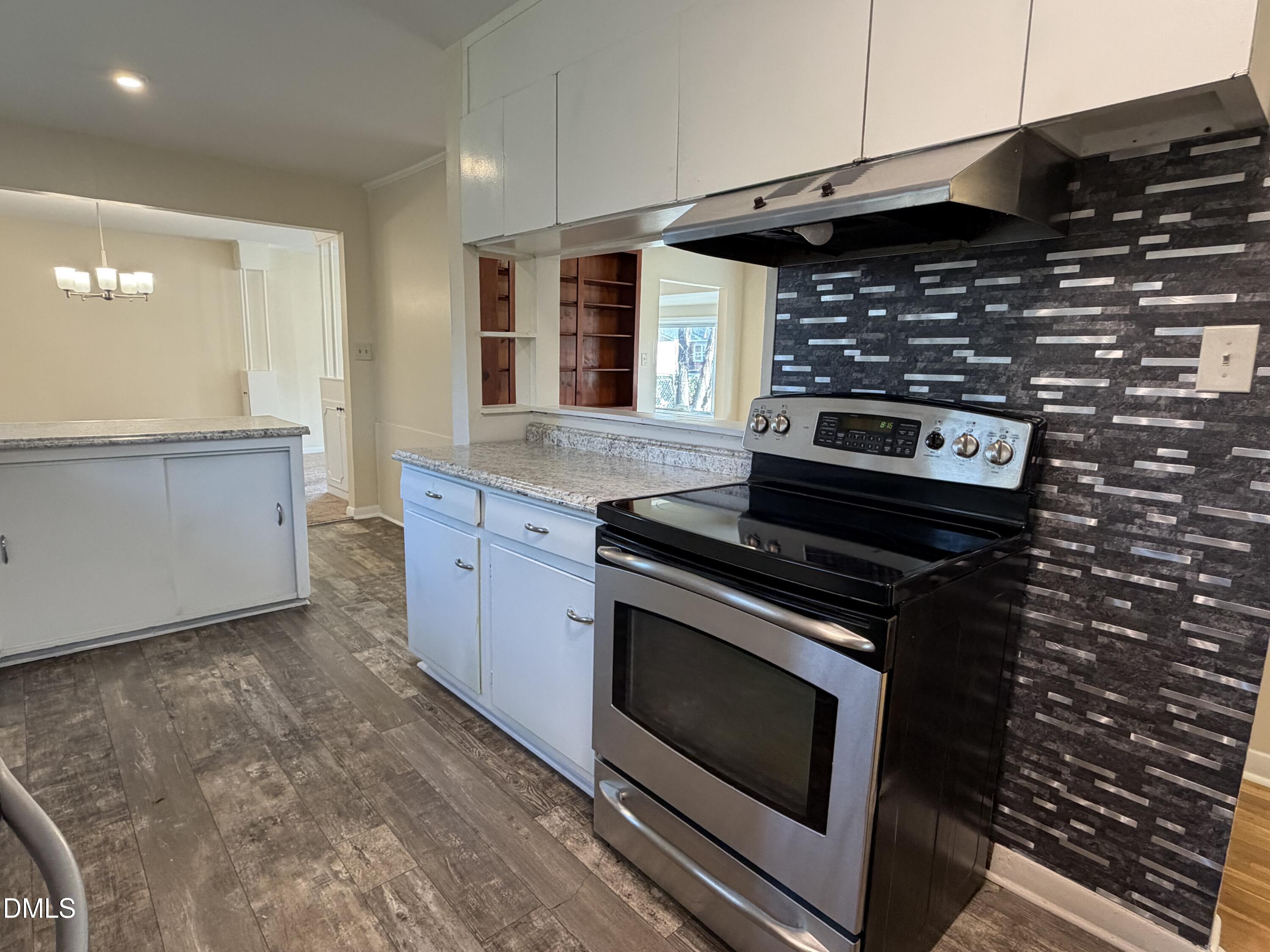 503 Spring Avenue Spring Lake, NC 28390 - Photo 13 of 36 a kitchen with granite countertop a stove and a sink