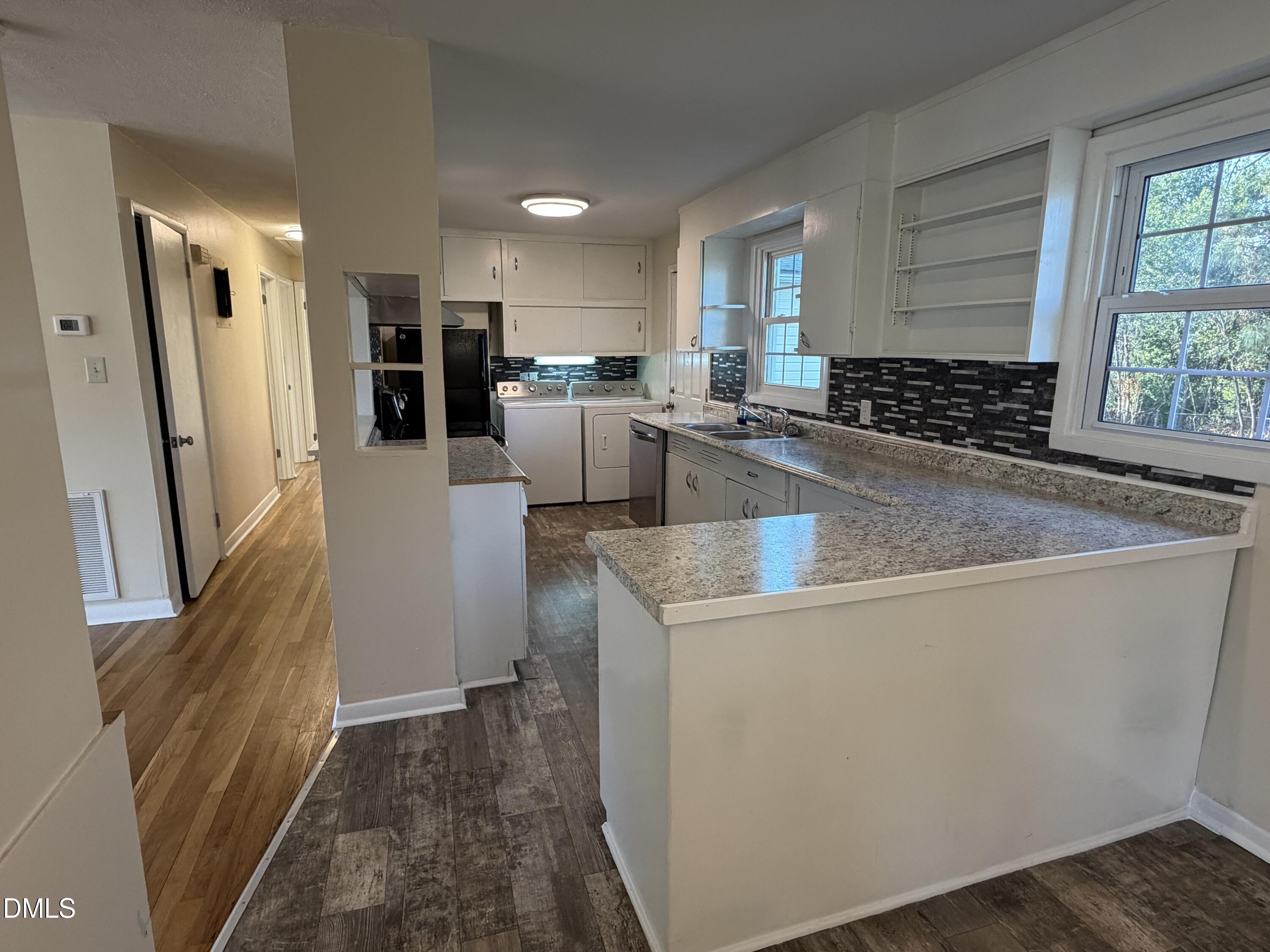 503 Spring Avenue Spring Lake, NC 28390 - Photo 14 of 36 a view of a kitchen with kitchen island a counter top space a sink stainless steel appliances and cabinets