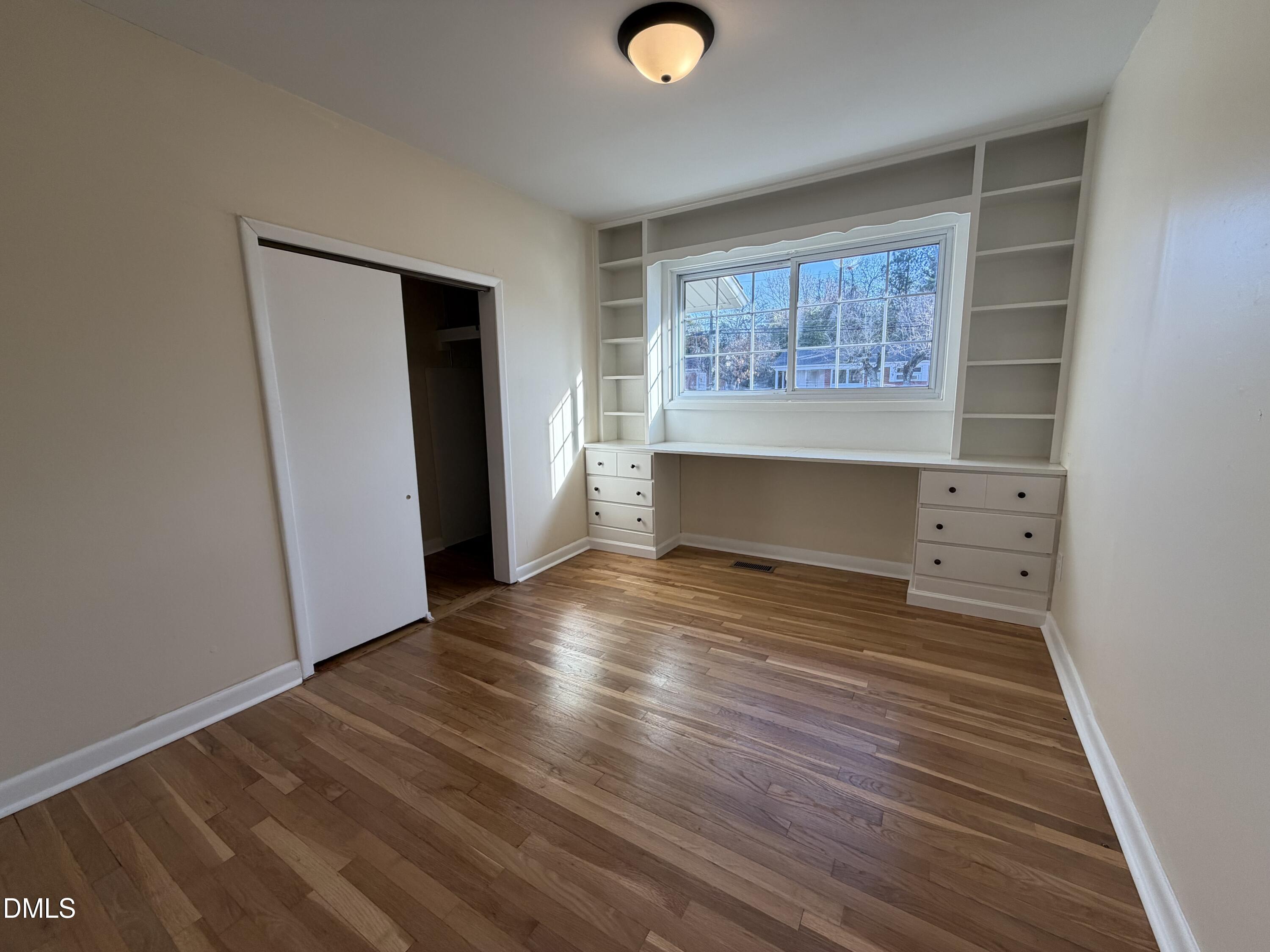 503 Spring Avenue Spring Lake, NC 28390 - Photo 18 of 36 an empty room with wooden floor and windows