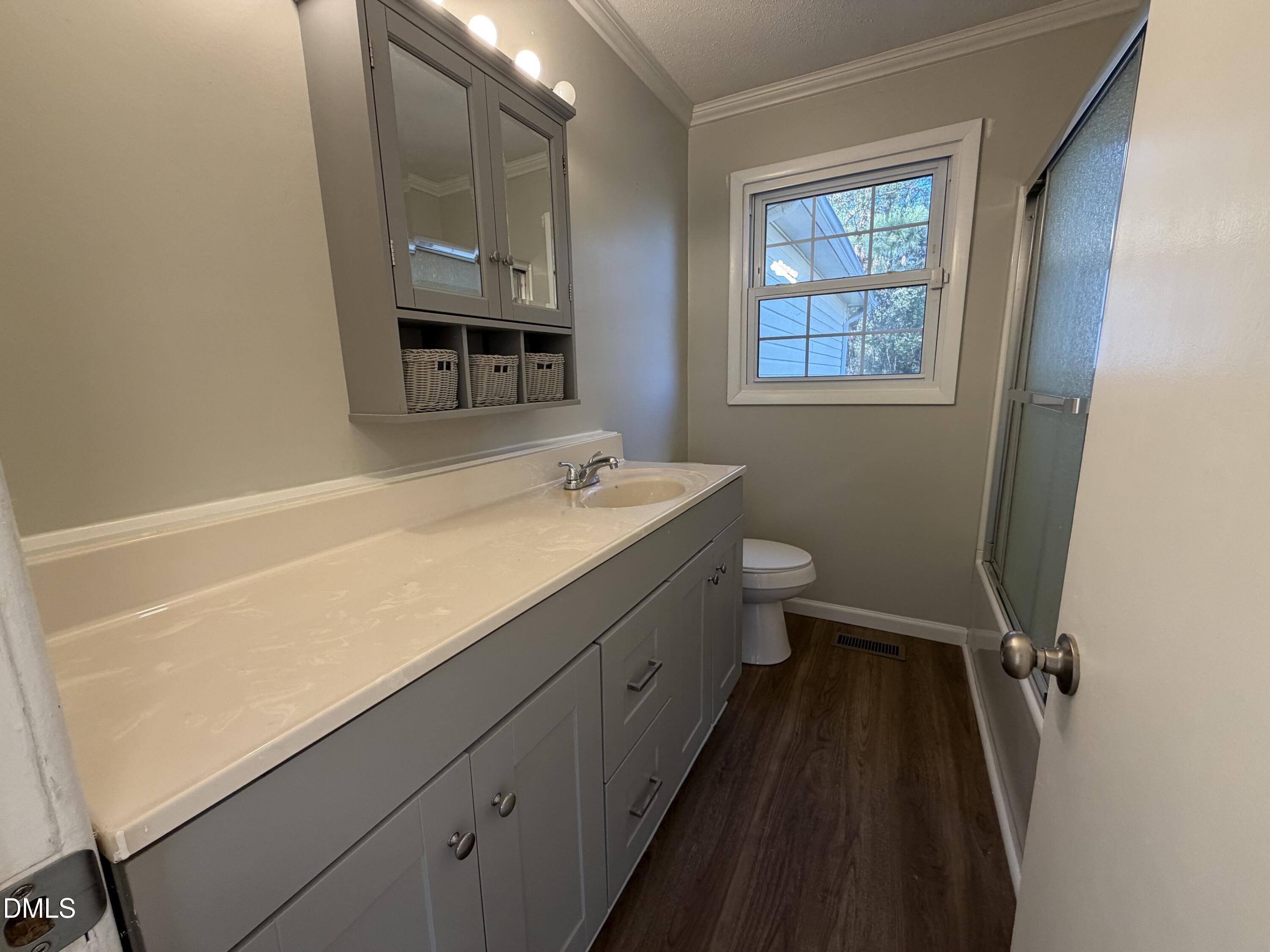 503 Spring Avenue Spring Lake, NC 28390 - Photo 20 of 36 a bathroom with a sink a toilet and a mirror