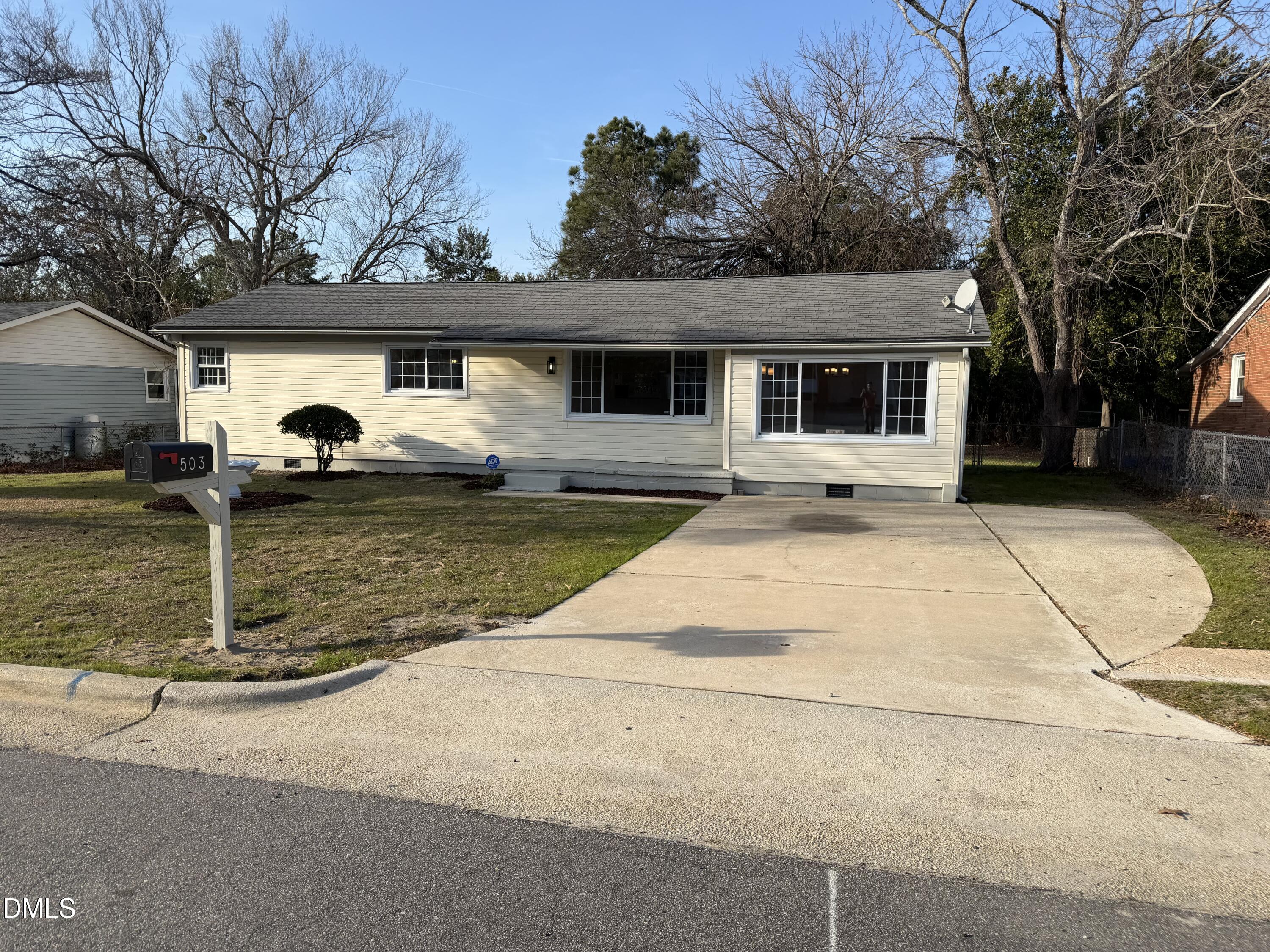 503 Spring Avenue Spring Lake, NC 28390 - Photo 2 of 36 a front view of a house with a yard and garage
