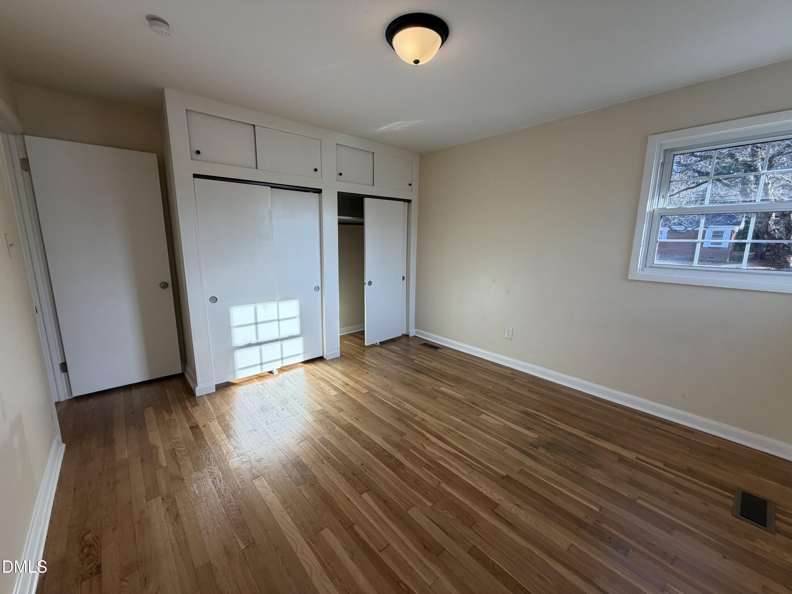 503 Spring Avenue Spring Lake, NC 28390 - Photo 23 of 36 a view of empty room with wooden floor and window
