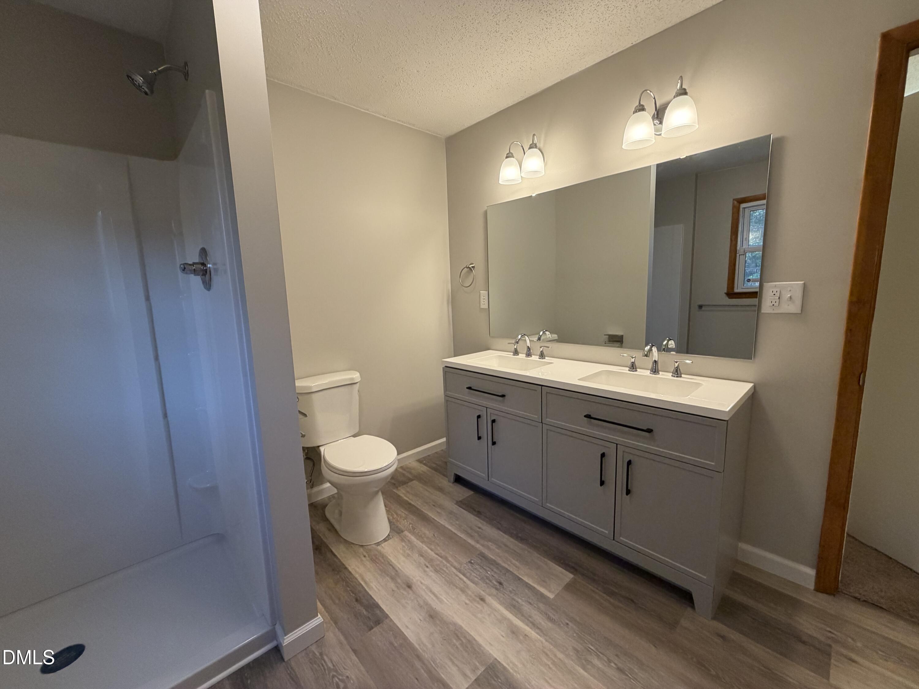 503 Spring Avenue Spring Lake, NC 28390 - Photo 26 of 36 a bathroom with a double vanity sink a toilet and a mirror