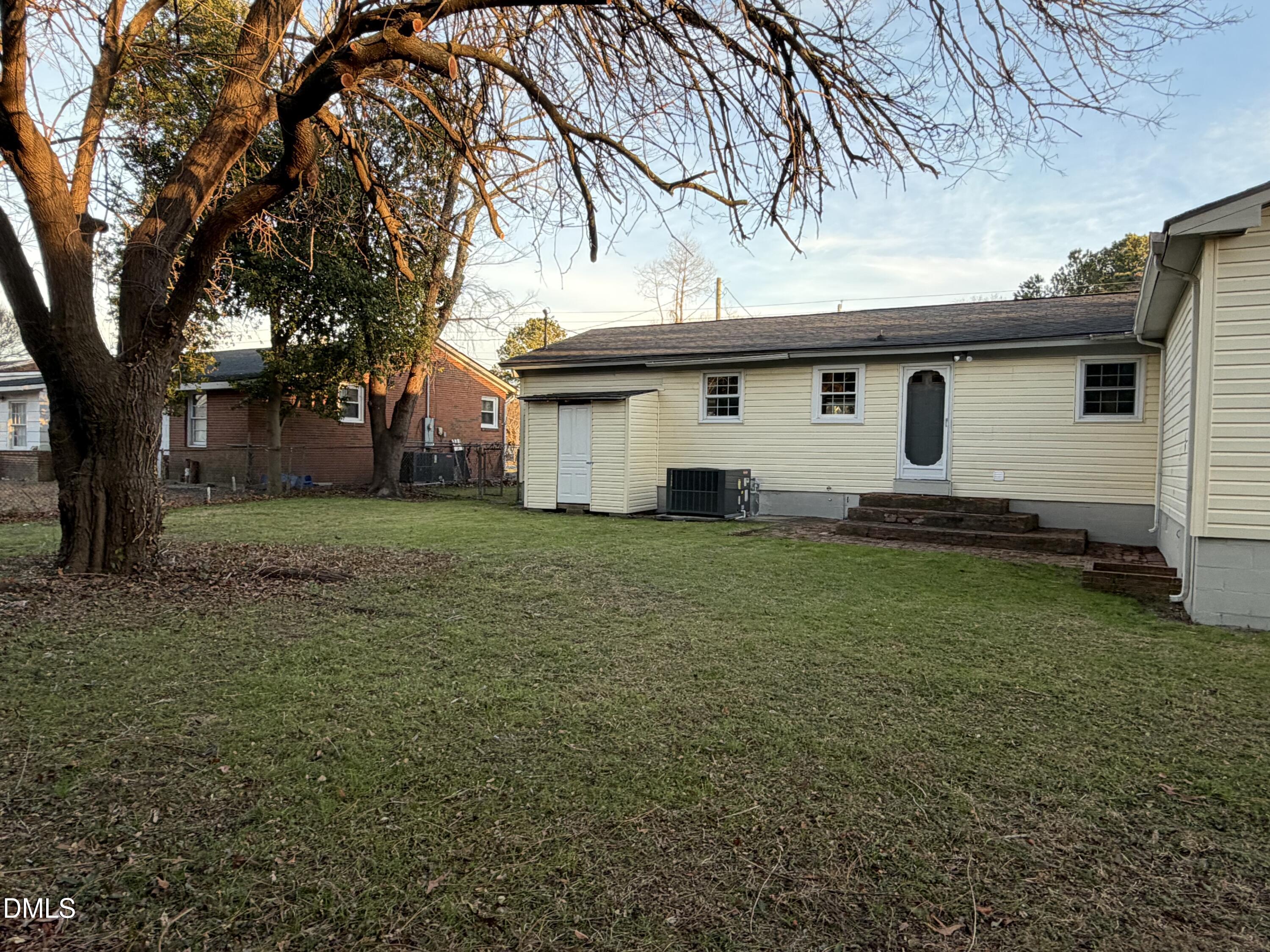 503 Spring Avenue Spring Lake, NC 28390 - Photo 33 of 36 a white house that has a tree in front of it
