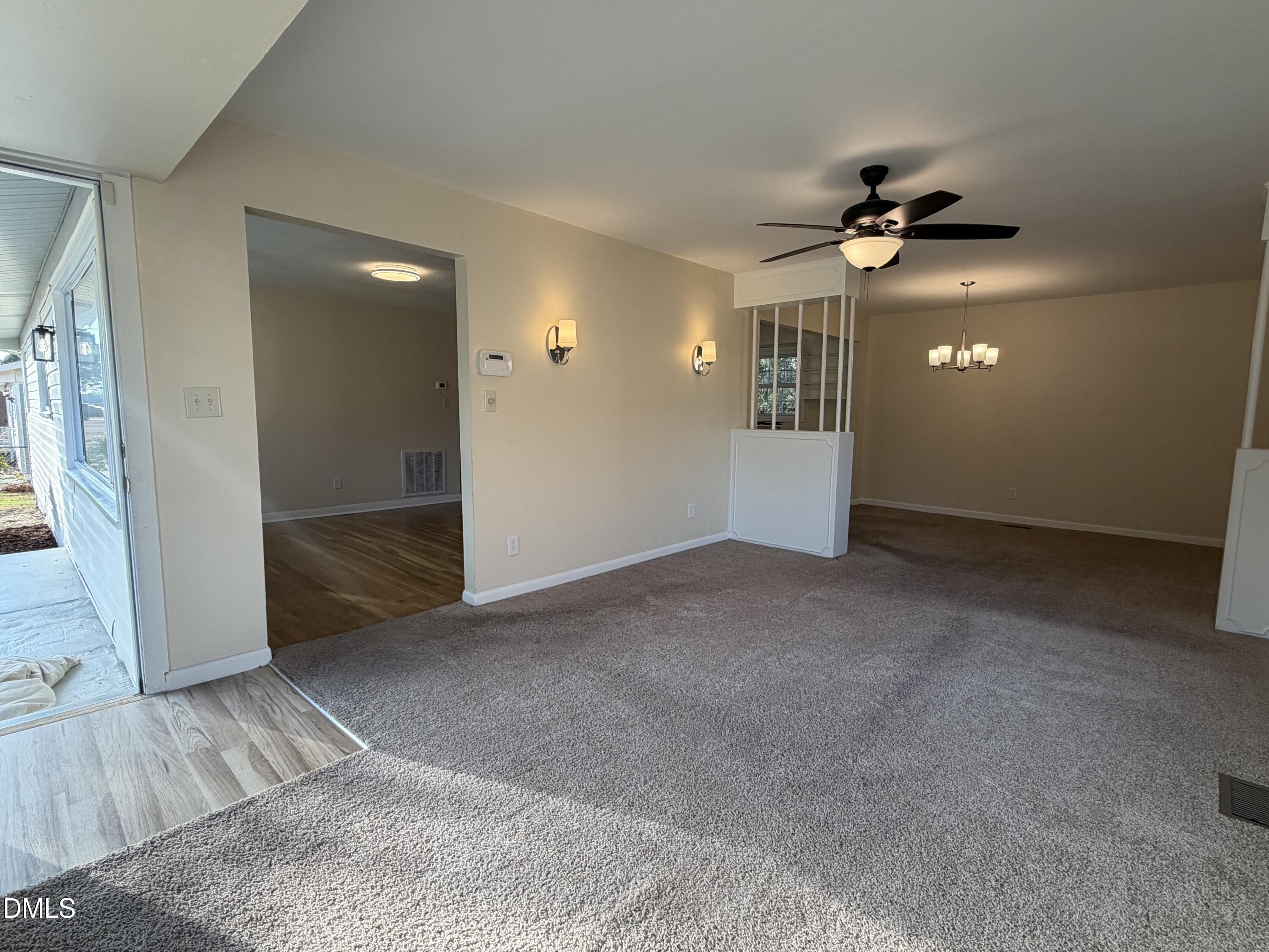503 Spring Avenue Spring Lake, NC 28390 - Photo 6 of 36 an empty room with wooden floor and windows