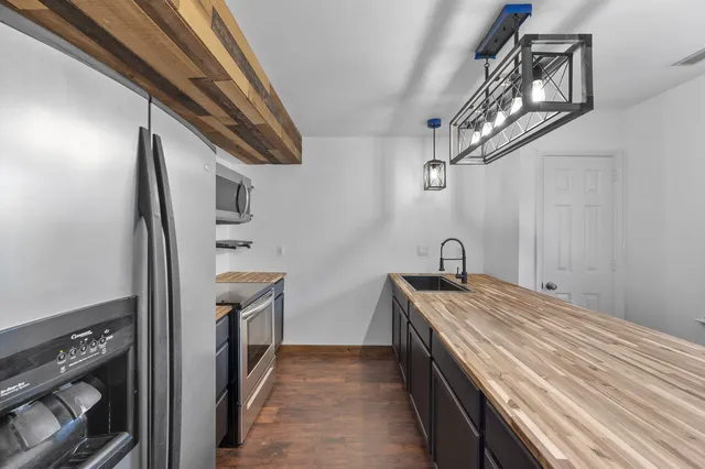 a kitchen with stainless steel appliances granite countertop a sink and stove