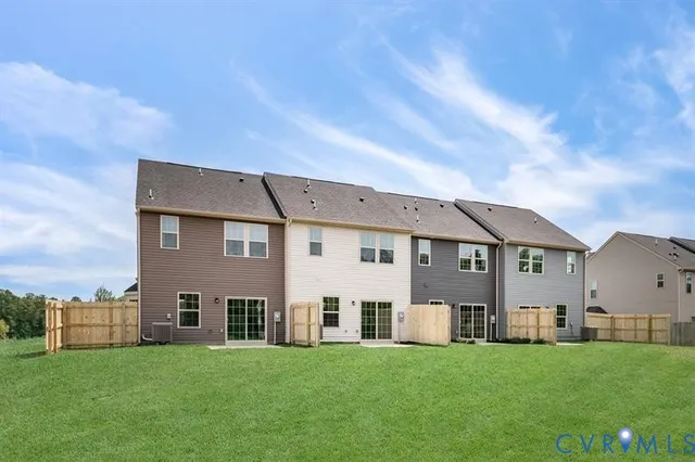 a view of a big house with a big yard and large trees