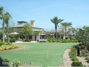 6441 Borasco Drive, Unit 2404 Melbourne, FL 32940 - Photo 28 of 28 a view of a white house with a big yard and potted plants