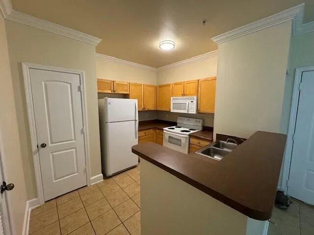 a kitchen with refrigerator cabinets and wooden floor