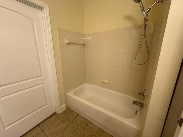 a white bath tub sitting next to a white sink and vanity