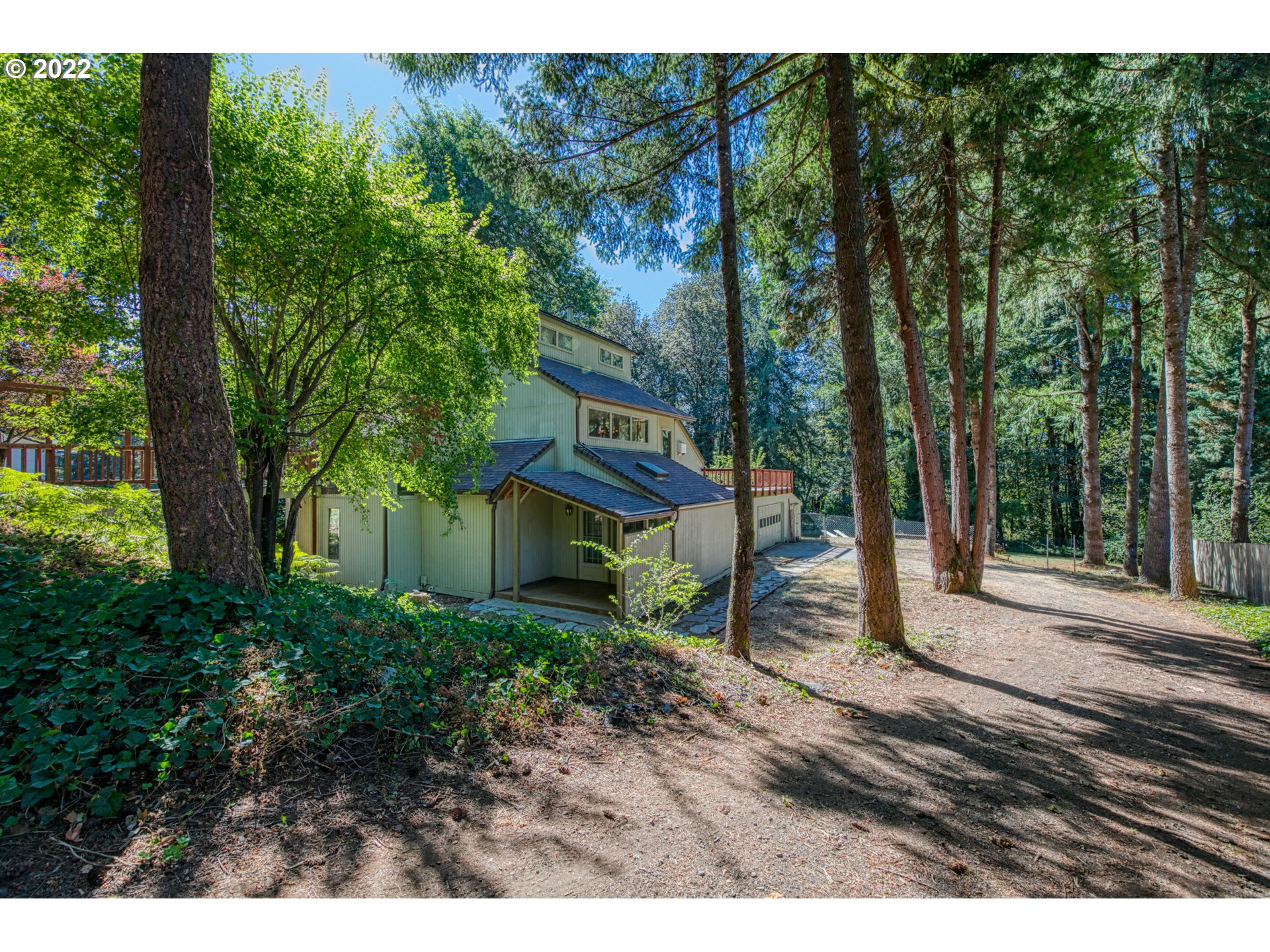 a view of a house with a tree in front of it