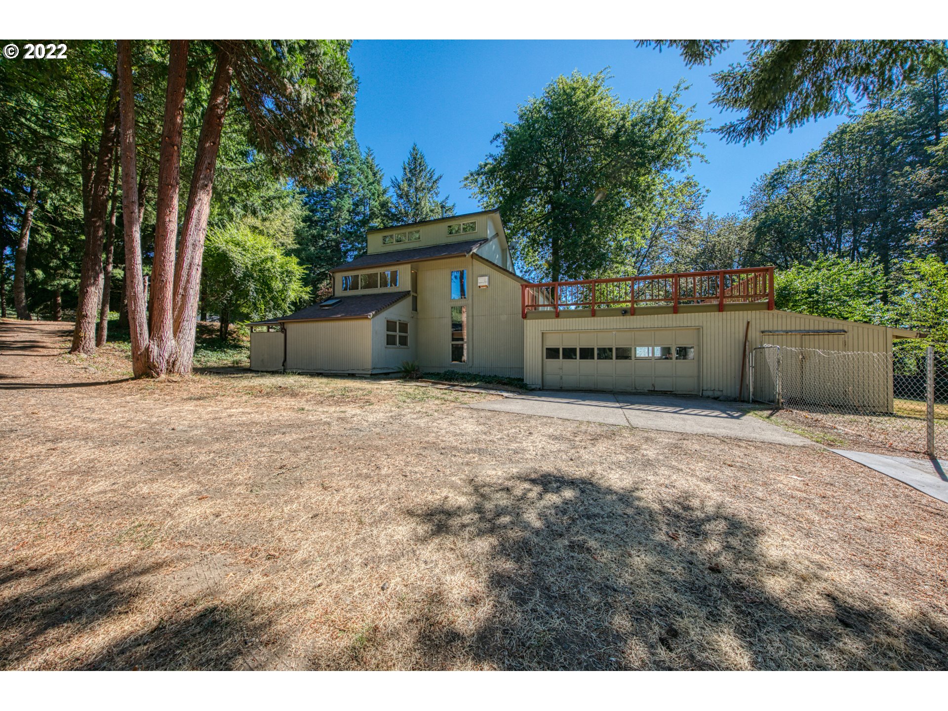 37821 Shenandoah Loop Springfield, OR 97478 - Photo 2 of 32 a backyard of a house with large trees and plants