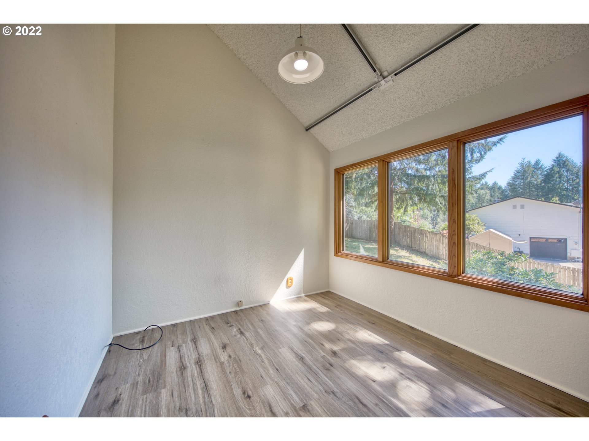 37821 Shenandoah Loop Springfield, OR 97478 - Photo 8 of 32 a view of an empty room with wooden floor and a window
