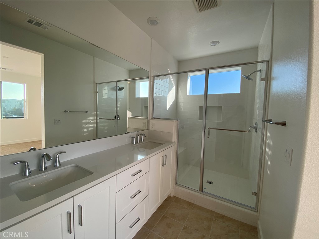 194 Sash Irvine, CA 92618 - Photo 14 of 18 a bathroom with a shower sink and mirror