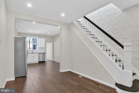 a view of an entryway with wooden floor