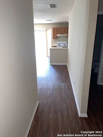 a view of hallway with wooden floor