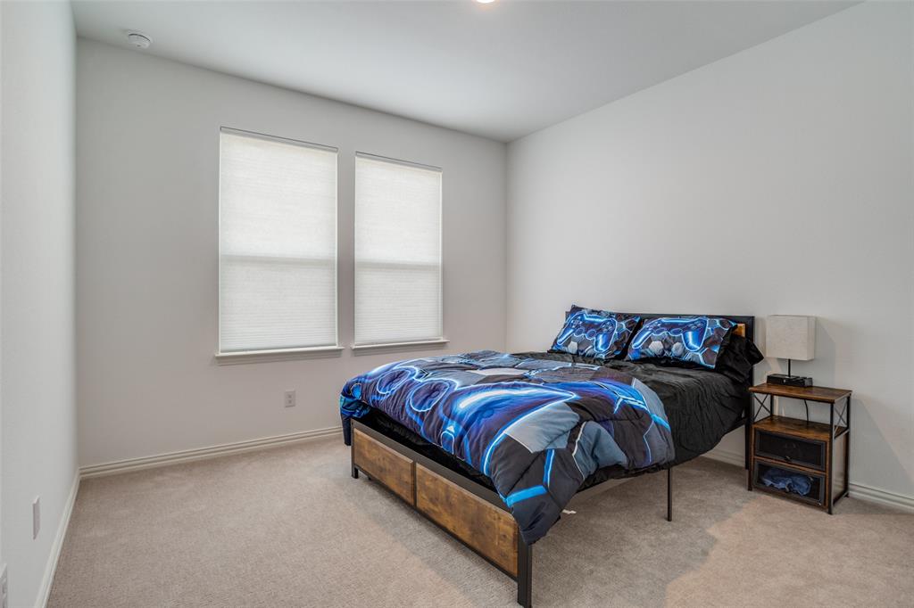15603 Palmwood Road Frisco, TX 75033 - Photo 10 of 12 a bed sitting in a bedroom next to a window