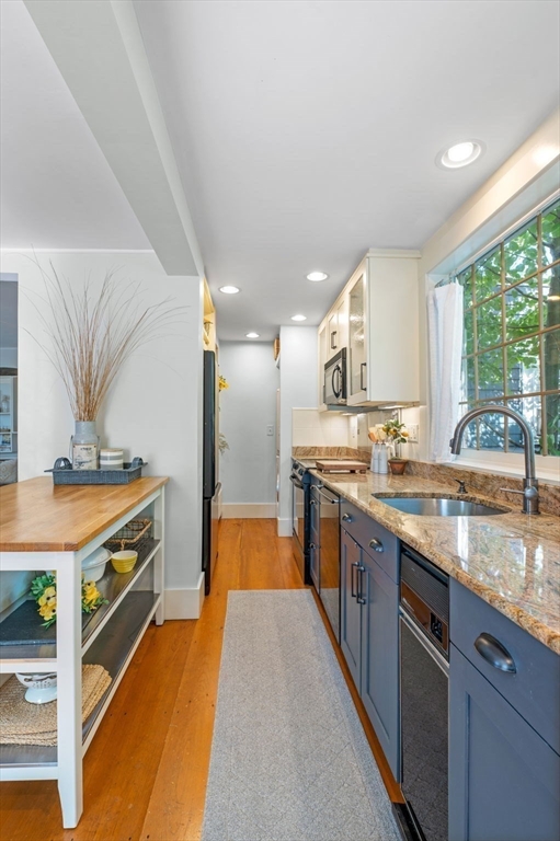 29 Front Street, Unit 2 Marblehead, MA 01945 - Photo 11 of 38 a large kitchen with stainless steel appliances granite countertop a lot of counter space and a wooden floors