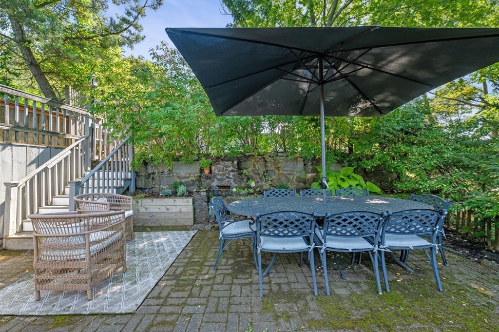 29 Front Street, Unit 2 Marblehead, MA 01945 - Photo 24 of 38 a patio with wooden floor a yard a table and chairs