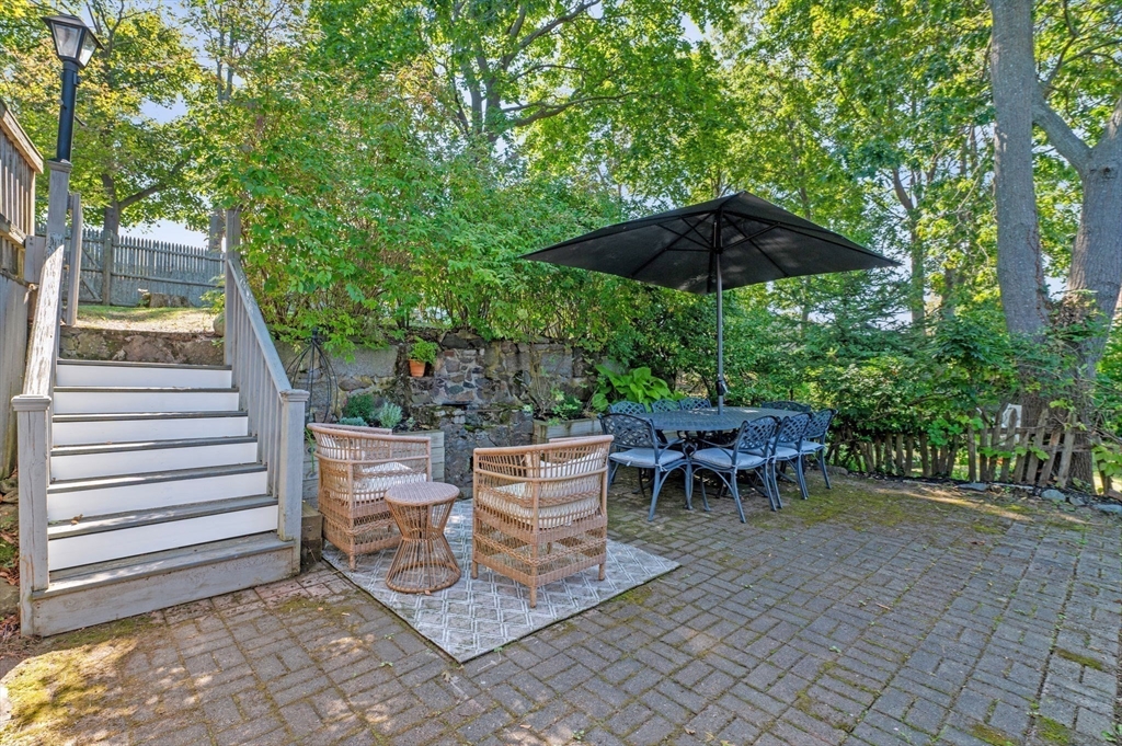 29 Front Street, Unit 2 Marblehead, MA 01945 - Photo 25 of 38 a view of a table and chairs under an umbrella in the patio