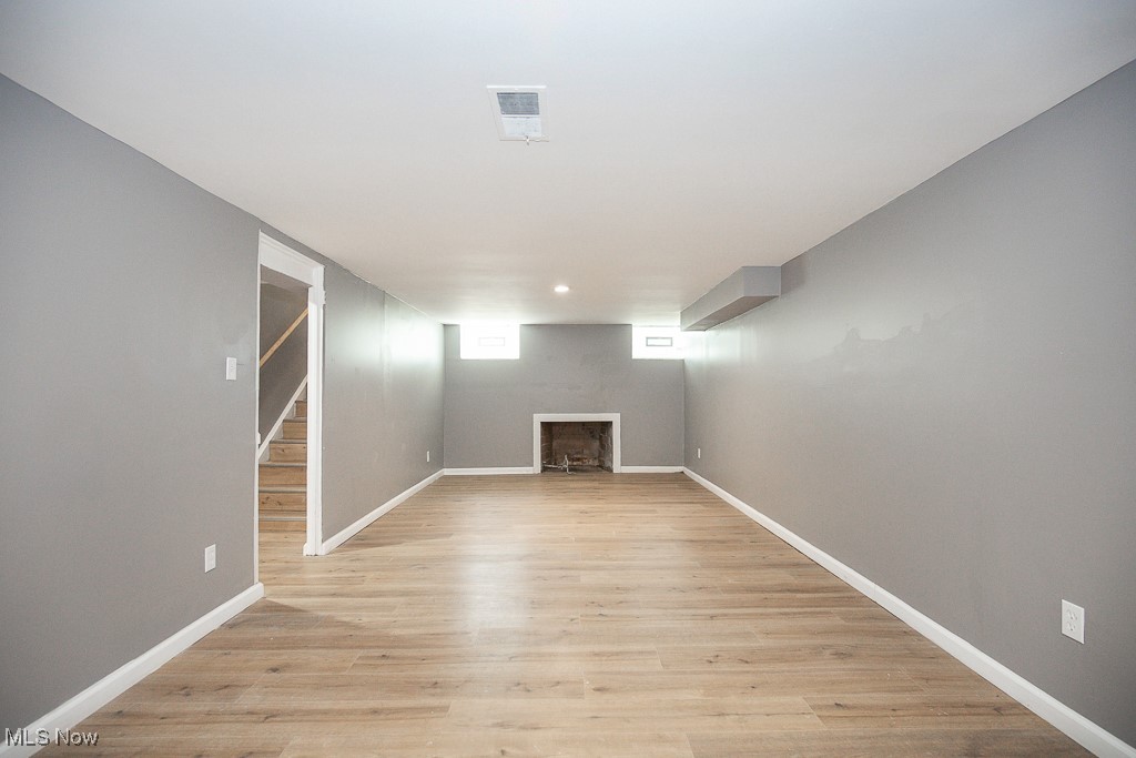 1547 Genesee Road South Euclid, OH 44121 - Photo 24 of 36 Below grade area featuring light wood finished floors, baseboards, and a fireplace