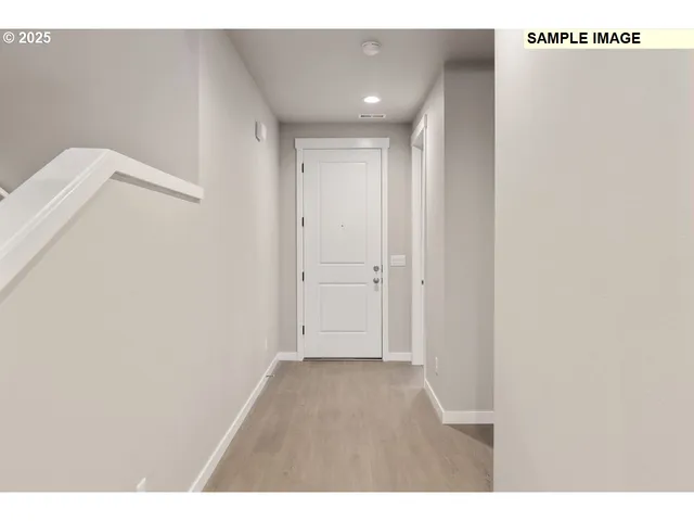 a view of hallway with wooden floor