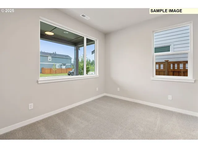 a view of empty room with wooden floor and closet