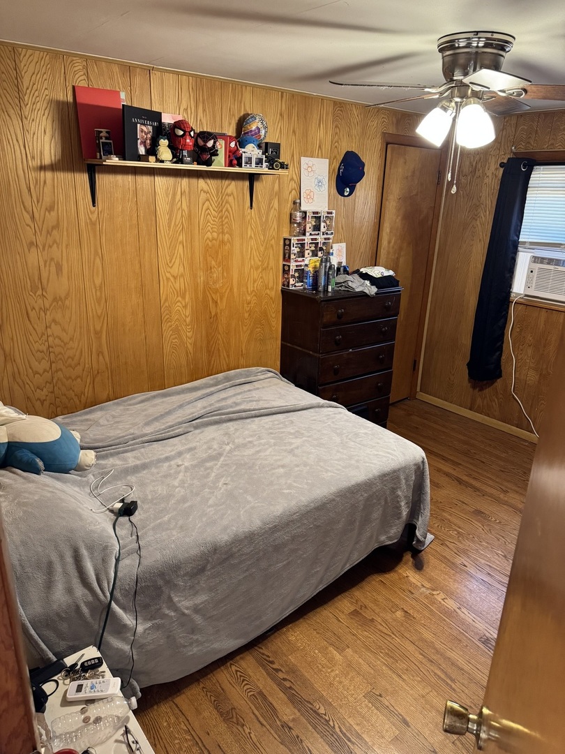 7836 Monitor Avenue Burbank, IL 60459 - Photo 17 of 26 a bedroom with a bed and a mirror