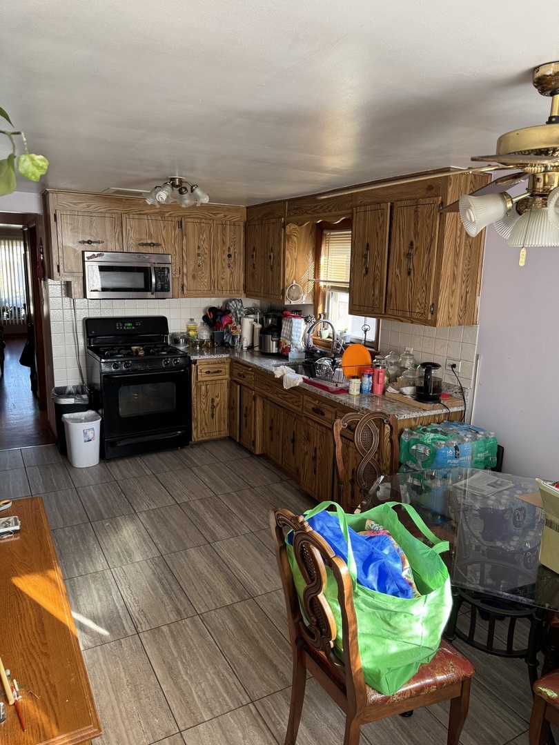 7836 Monitor Avenue Burbank, IL 60459 - Photo 18 of 26 a kitchen with stainless steel appliances kitchen island granite countertop a refrigerator and a stove top oven