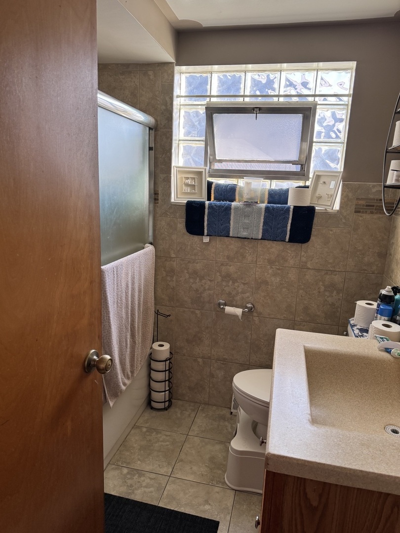 7836 Monitor Avenue Burbank, IL 60459 - Photo 20 of 26 a bathroom with a sink and a mirror