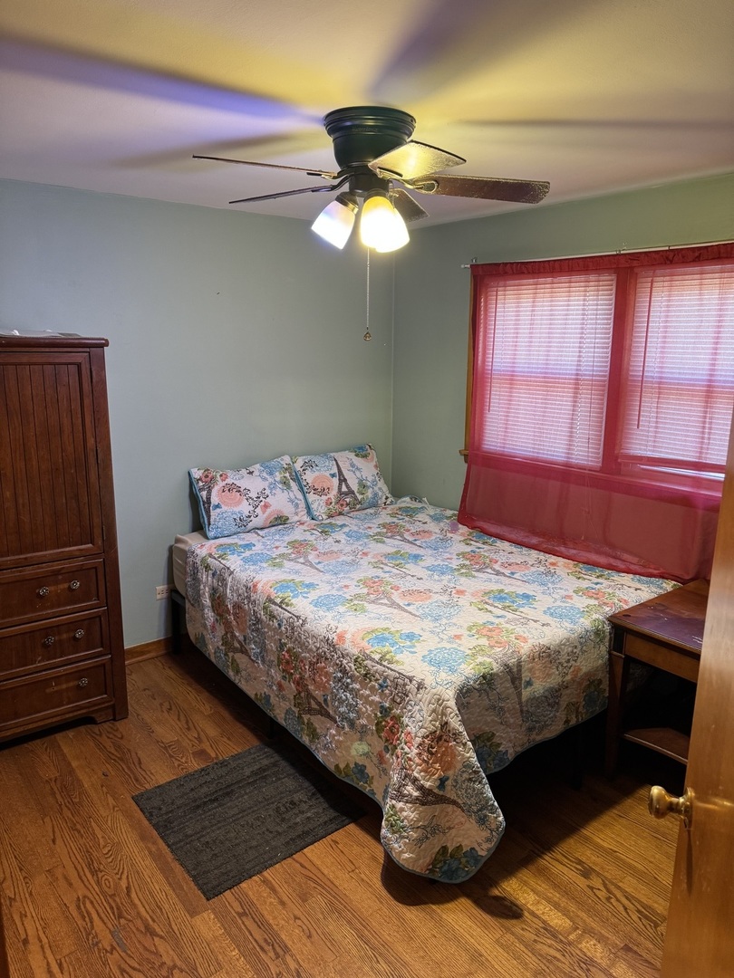 7836 Monitor Avenue Burbank, IL 60459 - Photo 22 of 26 a bedroom with a bed and a window